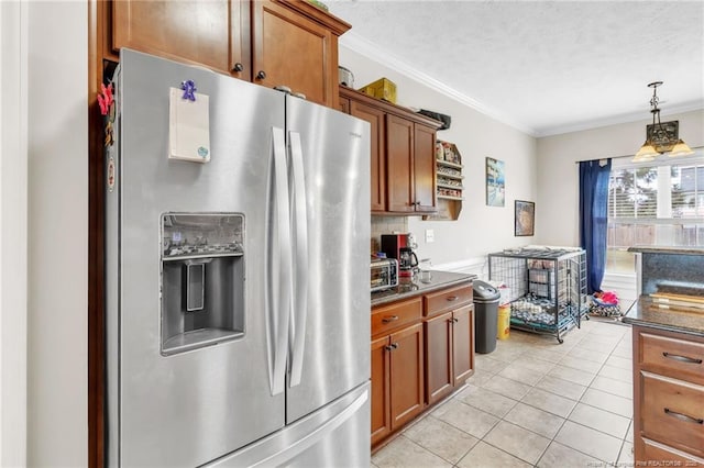 110 Wynngate Dr, Cameron, NC 28326 - kitchen with stainless steel refrigerator with ice dispenser, ornamental molding, brown cabinets, and dark countertops