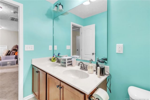 110 Wynngate Dr, Cameron, NC 28326 - bathroom with double vanity, toilet, visible vents, and a sink