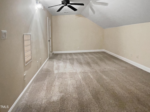 additional living space with baseboards, carpet, ceiling fan, and lofted ceiling