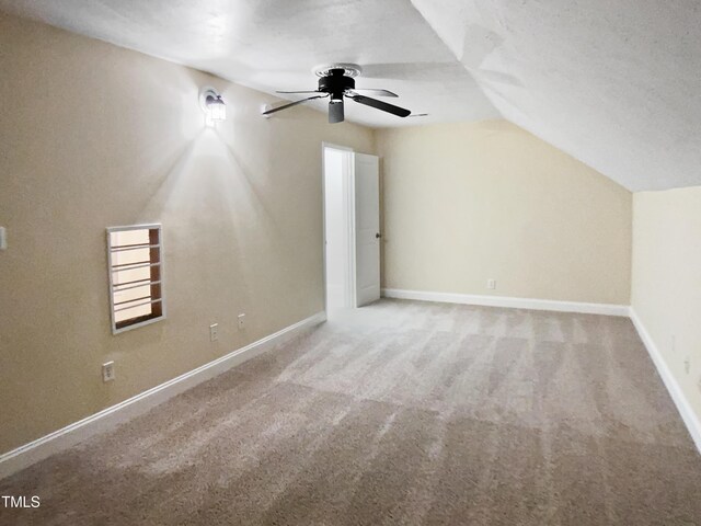 bonus room with a ceiling fan, baseboards, vaulted ceiling, and carpet