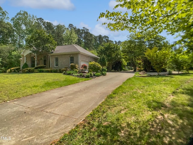 view of side of property with an attached garage and a yard