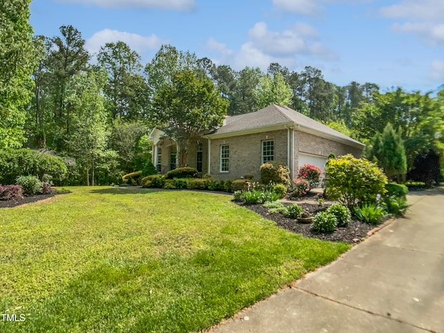view of side of home with a yard and an attached garage