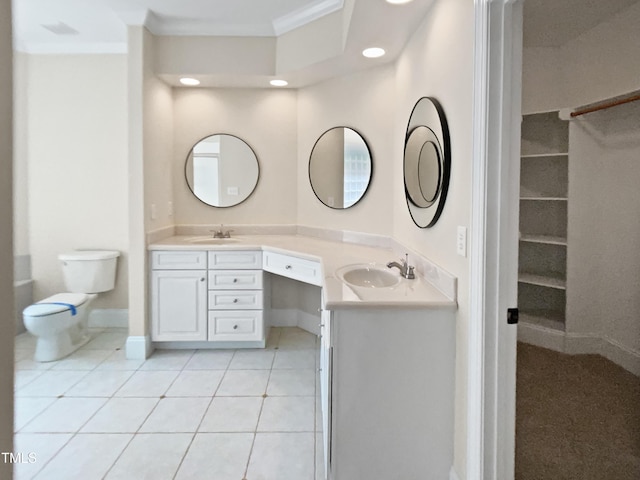 bathroom featuring double vanity, ornamental molding, a sink, and tile patterned flooring