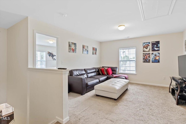 3912 Huntsmoor Ln, Wilson, NC 27896 - carpeted living room featuring baseboards, attic access, and a wealth of natural light