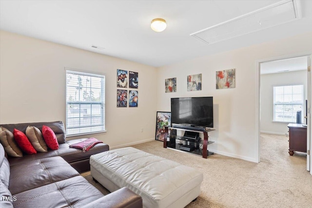 3912 Huntsmoor Ln, Wilson, NC 27896 - carpeted living area featuring baseboards, visible vents, attic access, and a wealth of natural light
