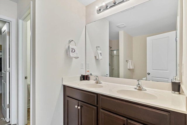 3912 Huntsmoor Ln, Wilson, NC 27896 - full bathroom with a sink, toilet, an enclosed shower, and double vanity