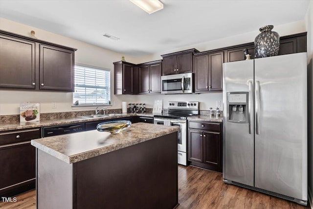 3912 Huntsmoor Ln, Wilson, NC 27896 - kitchen featuring dark brown cabinetry, visible vents, appliances with stainless steel finishes, dark wood finished floors, and a sink