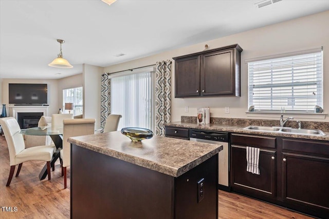 3912 Huntsmoor Ln, Wilson, NC 27896 - kitchen featuring dark brown cabinetry, a kitchen island, dark countertops, stainless steel dishwasher, and a sink