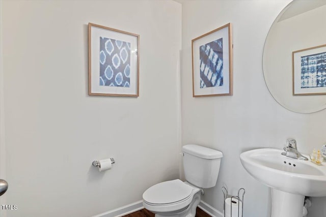3912 Huntsmoor Ln, Wilson, NC 27896 - half bath with toilet, baseboards, and a sink