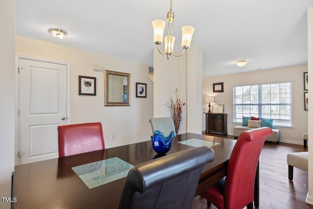 3912 Huntsmoor Ln, Wilson, NC 27896 - dining area featuring baseboards, wood finished floors, and a chandelier