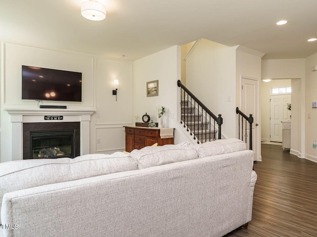 555 Whitley Ridge Dr, Clayton, NC 27527 - living room with dark wood-style flooring, stairs, recessed lighting, baseboards, and a glass covered fireplace