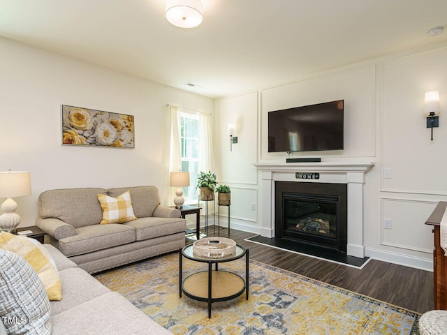 555 Whitley Ridge Dr, Clayton, NC 27527 - living room featuring wood finished floors, a glass covered fireplace, and a decorative wall