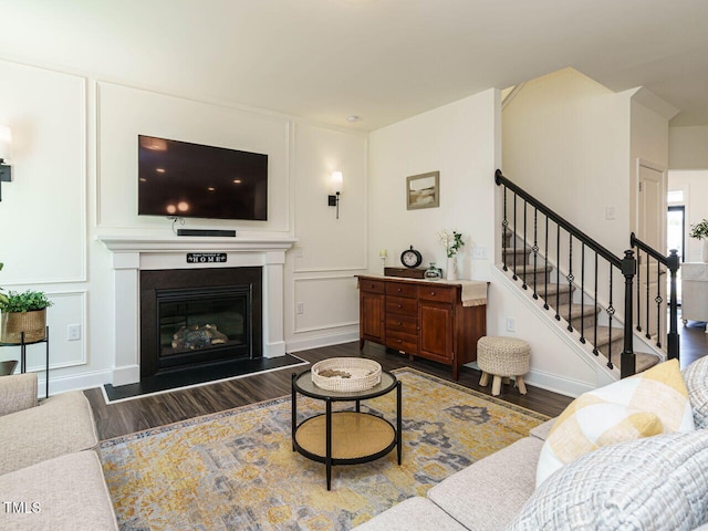 555 Whitley Ridge Dr, Clayton, NC 27527 - living room featuring wood finished floors, stairway, a glass covered fireplace, and baseboards