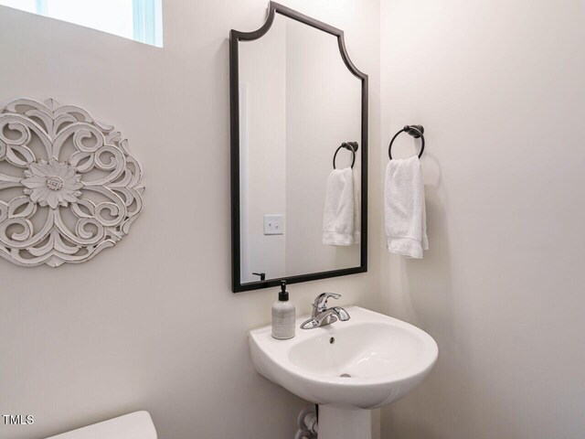 555 Whitley Ridge Dr, Clayton, NC 27527 - half bathroom with a sink and toilet