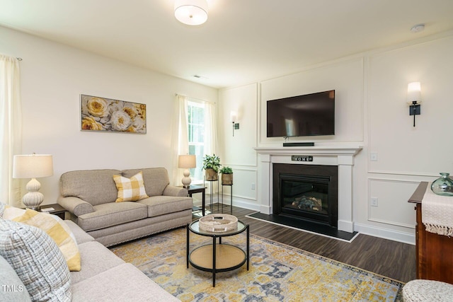 555 Whitley Ridge Dr, Clayton, NC 27527 - living room with wood finished floors, a glass covered fireplace, and a decorative wall