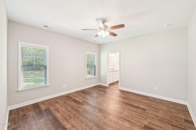 spare room featuring ceiling fan, baseboards, wood finished floors, and a smoke detector