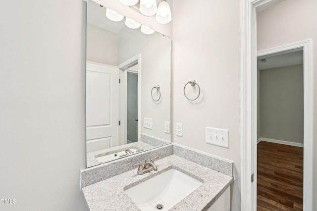 bathroom with wood finished floors and vanity
