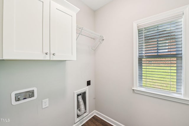 laundry room with washer hookup, baseboards, cabinet space, electric dryer hookup, and dark wood finished floors