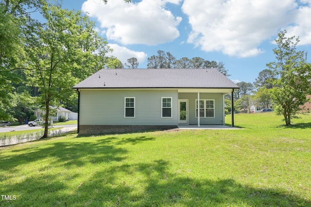 rear view of house with a patio area and a yard