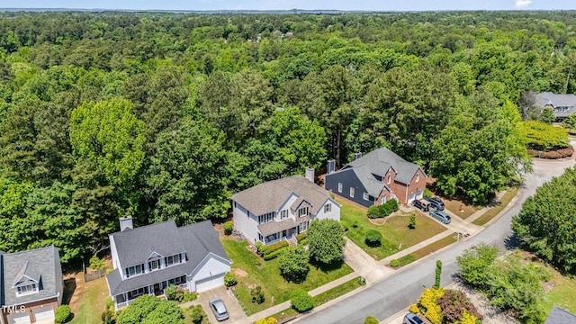 aerial view of residential area featuring a forest