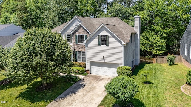 traditional-style home featuring a chimney, driveway, and a garage