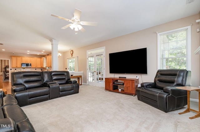 living area featuring light colored carpet, ornate columns, recessed lighting, and a ceiling fan