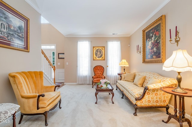 sitting room featuring carpet, healthy amount of natural light, crown molding, stairs, and baseboards
