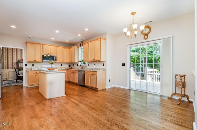 kitchen featuring stainless steel appliances, a chandelier, light brown cabinetry, light wood finished floors, and recessed lighting