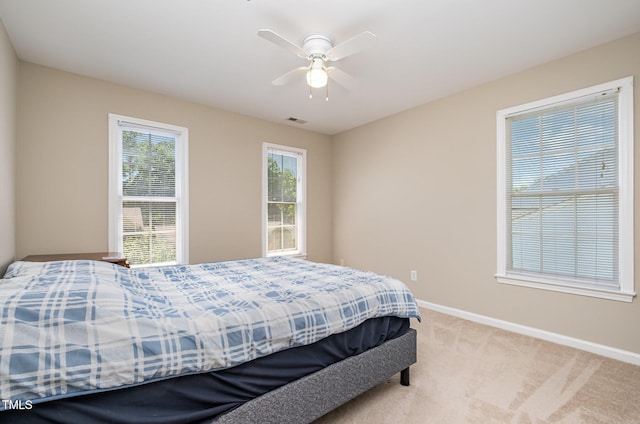 bedroom with baseboards, light colored carpet, and ceiling fan