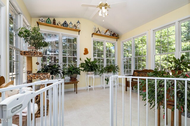sunroom / solarium featuring vaulted ceiling, baseboards, and tile patterned floors