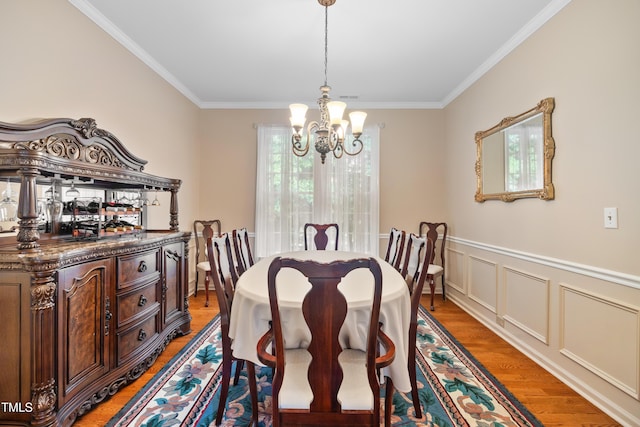 4608 Regency Dr, Durham, NC 27713 - dining room with a chandelier, ornamental molding, light wood finished floors, and a wainscoted wall