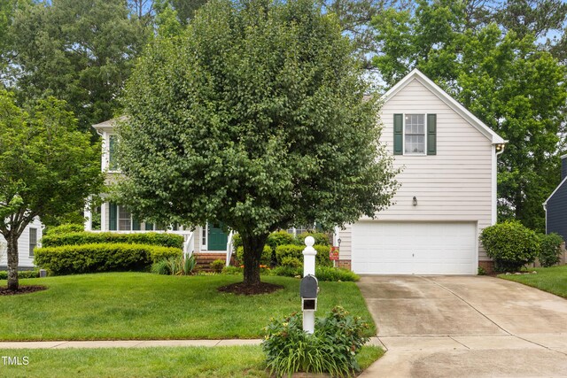 4608 Regency Dr, Durham, NC 27713 - view of property hidden behind natural elements with a garage, a front yard, and driveway