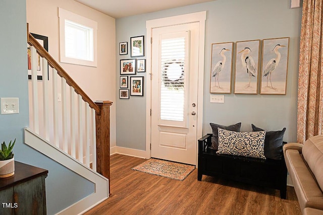 entrance foyer with baseboards, plenty of natural light, stairs, and wood finished floors