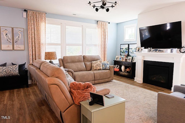 living room featuring visible vents, dark wood finished floors, and a fireplace