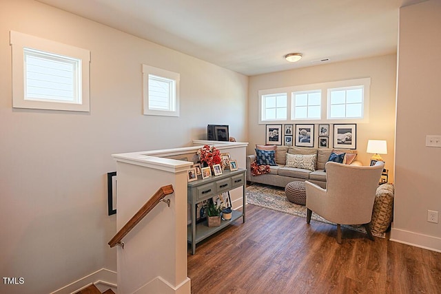 living area with baseboards and dark wood-style floors