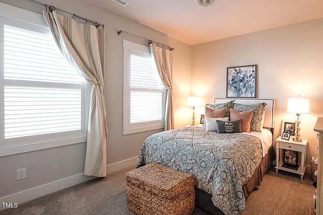 bedroom with baseboards and carpet
