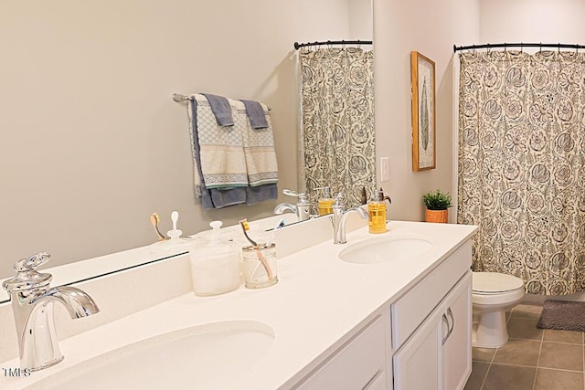 full bath with double vanity, toilet, a sink, and tile patterned flooring