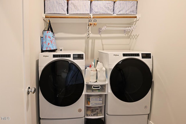 clothes washing area featuring laundry area and washer and dryer