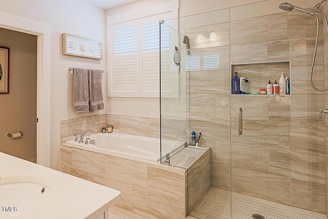 bathroom with a shower stall, a bath, and vanity