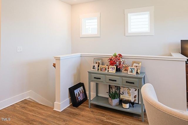 interior space featuring baseboards and wood finished floors