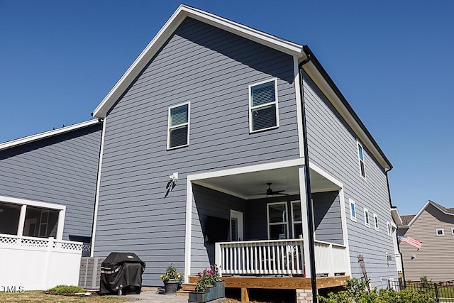 back of house with fence, ceiling fan, and a porch