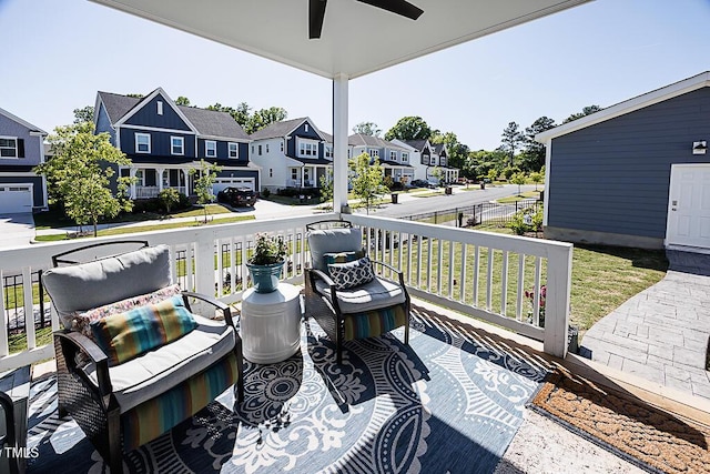 deck featuring ceiling fan, covered porch, and a residential view