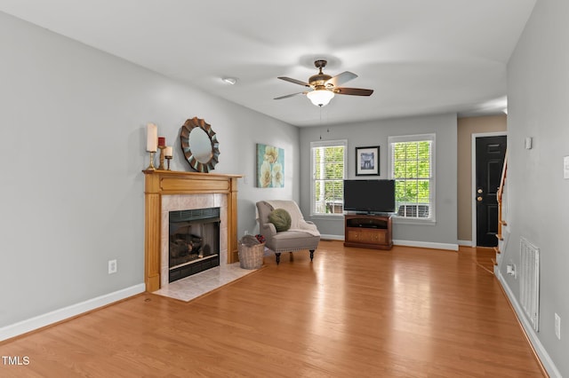 612 Lakeview Ave, Wake Forest, NC 27587 - sitting room with visible vents, baseboards, ceiling fan, light wood-type flooring, and a tile fireplace