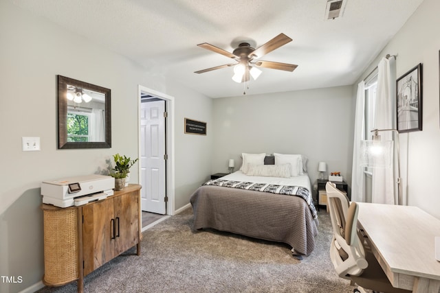 bedroom featuring a ceiling fan, baseboards, visible vents, and carpet