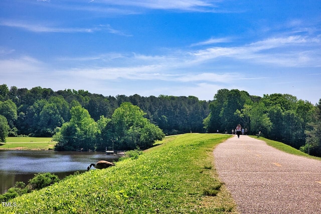 view of home's community with a water view and a forest view