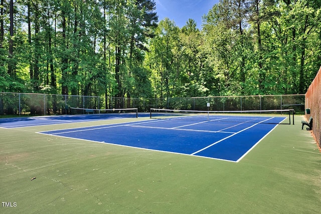 view of tennis court with fence