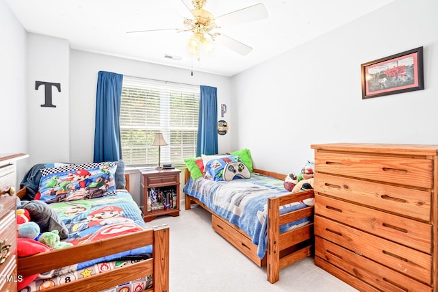 bedroom featuring ceiling fan, visible vents, and light carpet