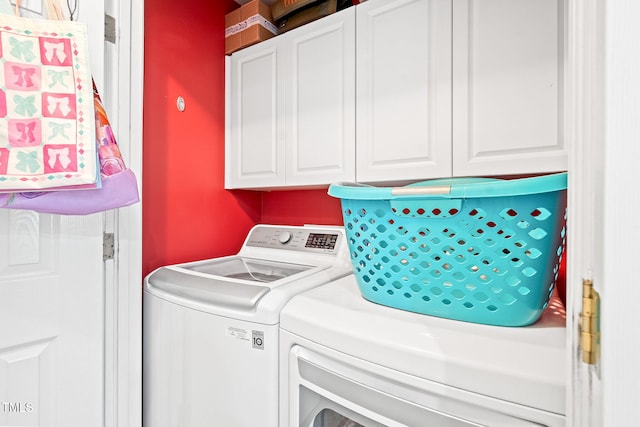 washroom with separate washer and dryer and cabinet space