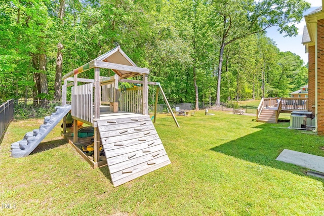 view of playground featuring a lawn, cooling unit, a wooden deck, and fence private yard
