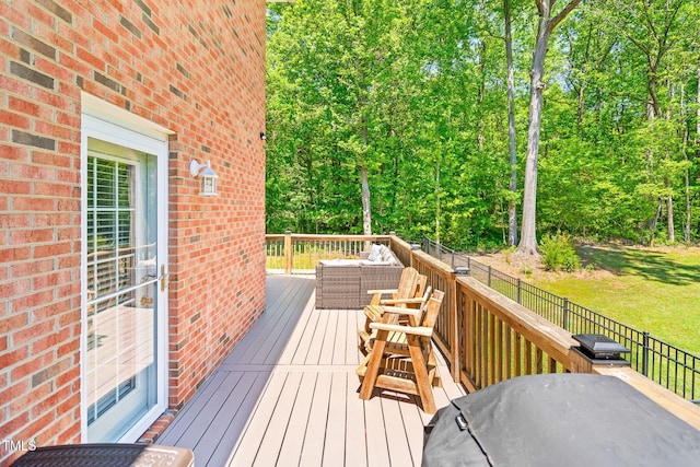 wooden terrace featuring fence and a yard